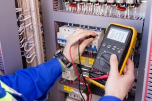 electrician measures voltage